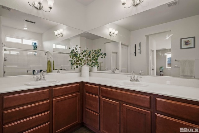 full bath featuring visible vents, a sink, and a shower stall