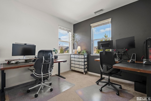 office featuring carpet, visible vents, and baseboards