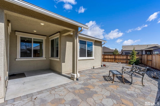 view of patio featuring fence