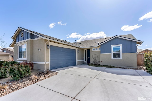 ranch-style home featuring a garage, concrete driveway, board and batten siding, and fence