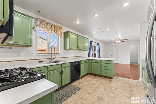 kitchen featuring dishwasher, a sink, stainless steel refrigerator, and green cabinetry