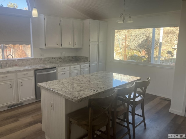 kitchen featuring stainless steel dishwasher, visible vents, dark wood-type flooring, and a sink