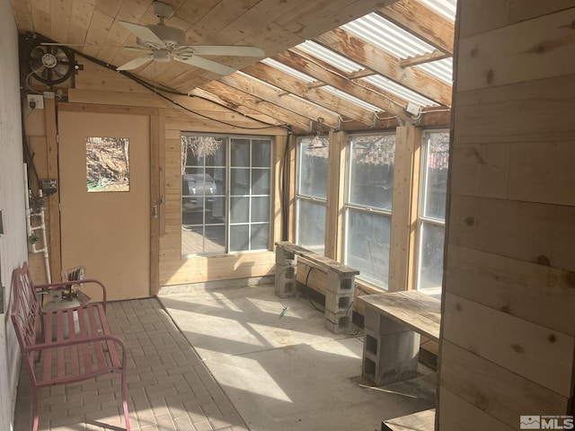 sunroom with a ceiling fan and vaulted ceiling