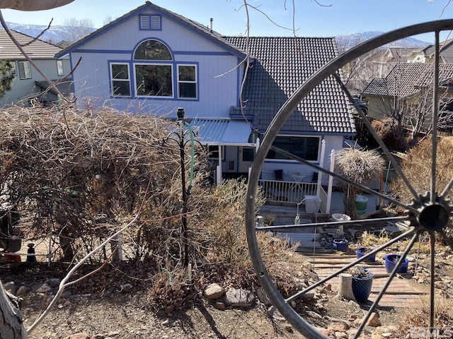 back of property with a tiled roof