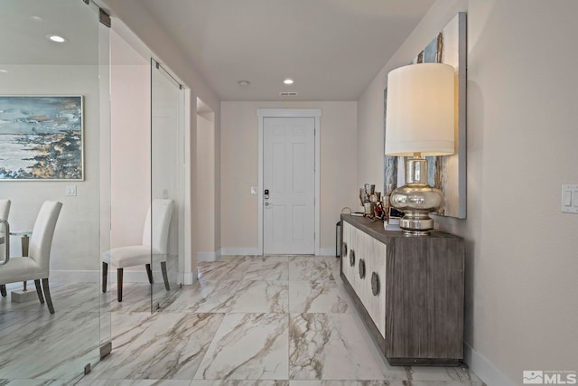 entrance foyer featuring recessed lighting, marble finish floor, and baseboards