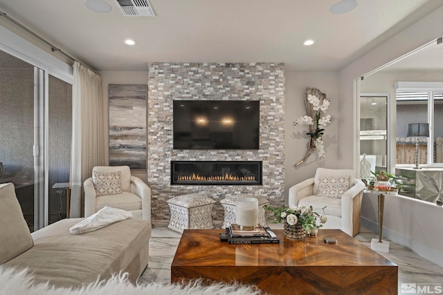 living area featuring recessed lighting, marble finish floor, visible vents, and a large fireplace