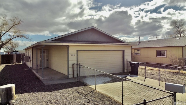 exterior space with concrete driveway and fence