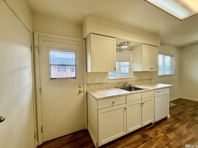 kitchen featuring white cabinetry, white dishwasher, tile counters, and a sink