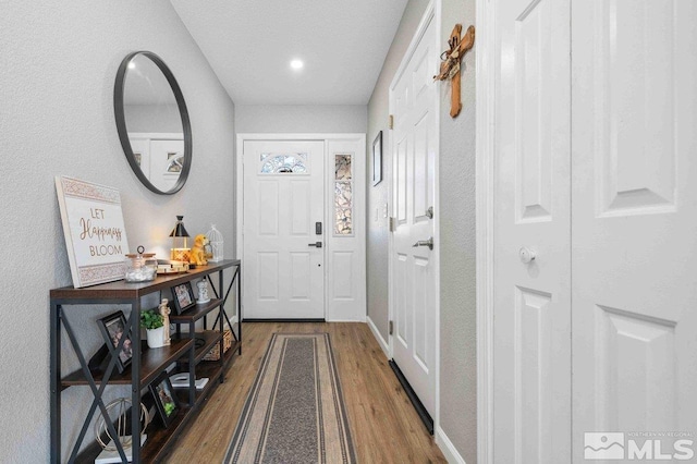 doorway to outside with wood finished floors