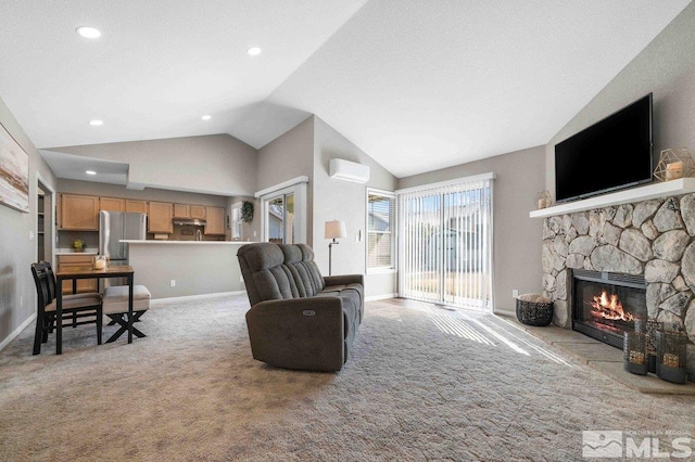 living room featuring baseboards, light colored carpet, lofted ceiling, a stone fireplace, and a wall mounted AC