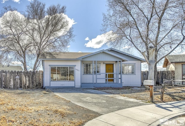 view of front of home featuring fence and a porch