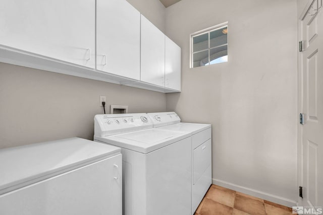 laundry area with washer and dryer, baseboards, and cabinet space