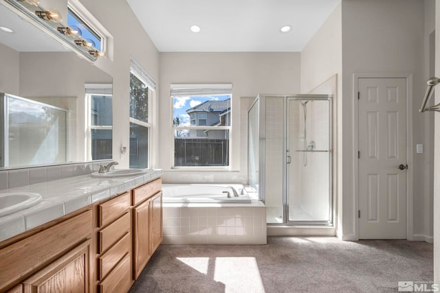 full bathroom with a garden tub, a stall shower, a sink, recessed lighting, and double vanity