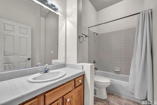 bathroom featuring tile patterned floors, shower / bath combo with shower curtain, toilet, and vanity