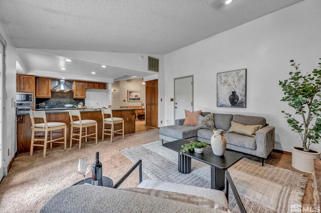 living area featuring visible vents, light colored carpet, vaulted ceiling, recessed lighting, and a textured ceiling