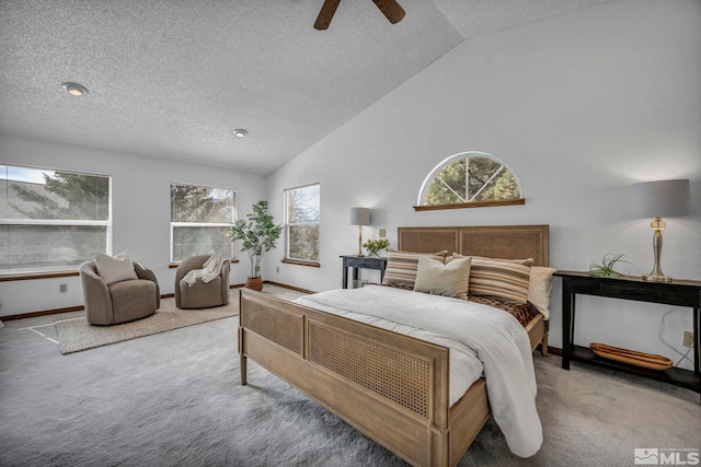 carpeted bedroom with baseboards, high vaulted ceiling, a textured ceiling, and a ceiling fan