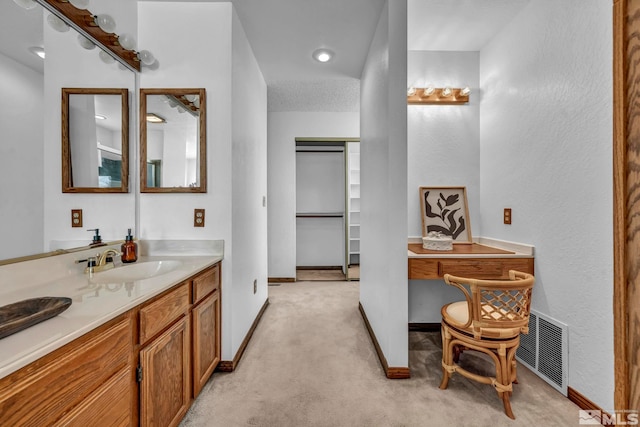 bathroom with visible vents, vanity, and baseboards