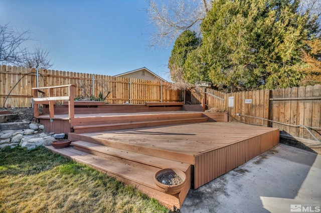 wooden terrace featuring a fenced backyard