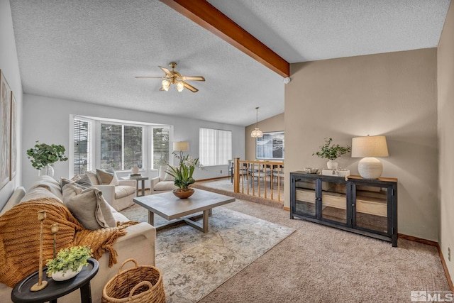 carpeted living room with ceiling fan, a textured ceiling, lofted ceiling with beams, and baseboards