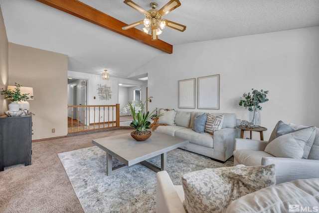 carpeted living area featuring vaulted ceiling with beams, a ceiling fan, baseboards, and a textured ceiling