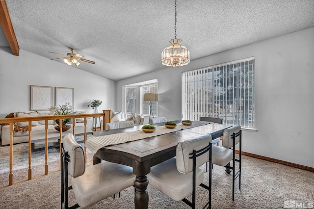 dining area featuring baseboards, carpet floors, lofted ceiling, a textured ceiling, and ceiling fan with notable chandelier