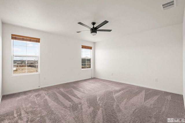 unfurnished room with visible vents, baseboards, ceiling fan, and carpet flooring