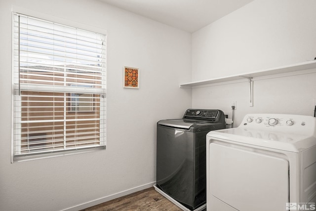 laundry room featuring laundry area, wood finished floors, baseboards, and washer and clothes dryer