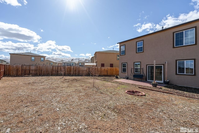 view of yard featuring a patio, a fenced backyard, and an outdoor fire pit