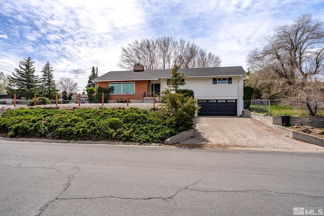 single story home featuring fence, a garage, driveway, and a chimney