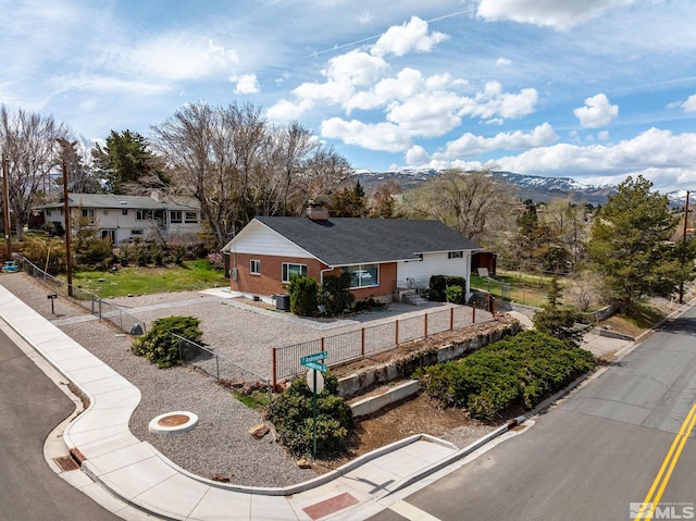 view of front facade featuring fence and a mountain view