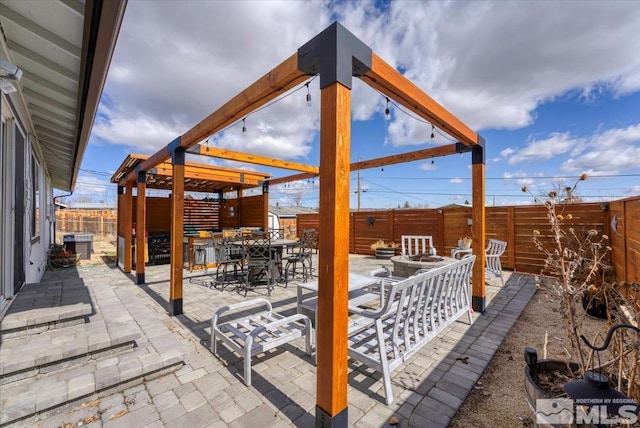 view of patio with outdoor dining space, cooling unit, and a fenced backyard