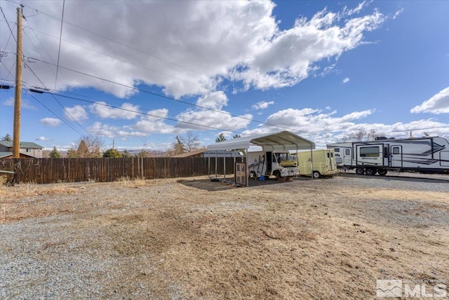 view of yard featuring a carport and fence