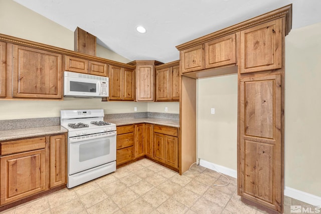 kitchen with white appliances, light countertops, brown cabinets, and lofted ceiling