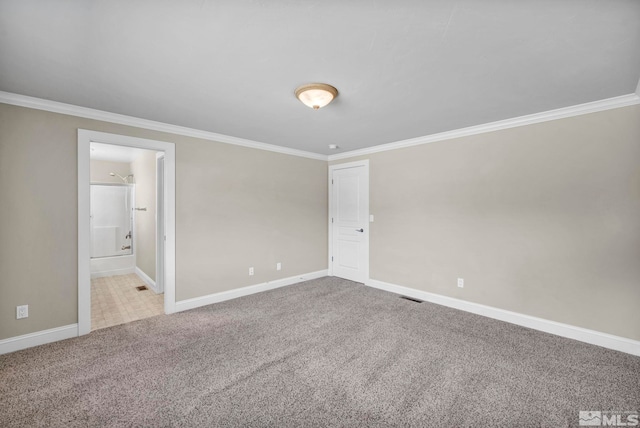 unfurnished bedroom with visible vents, ornamental molding, connected bathroom, carpet, and baseboards