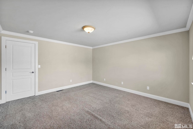 empty room featuring visible vents, baseboards, crown molding, and carpet