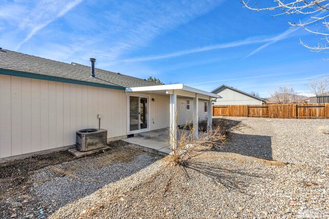 back of house featuring a patio, roof with shingles, central AC, and fence