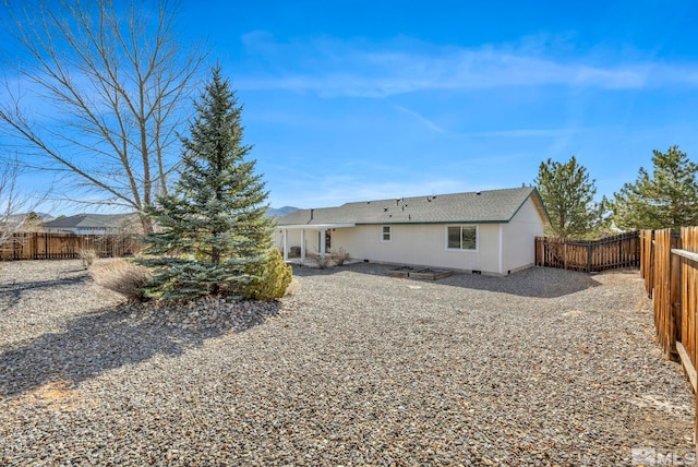 rear view of house with a patio and a fenced backyard