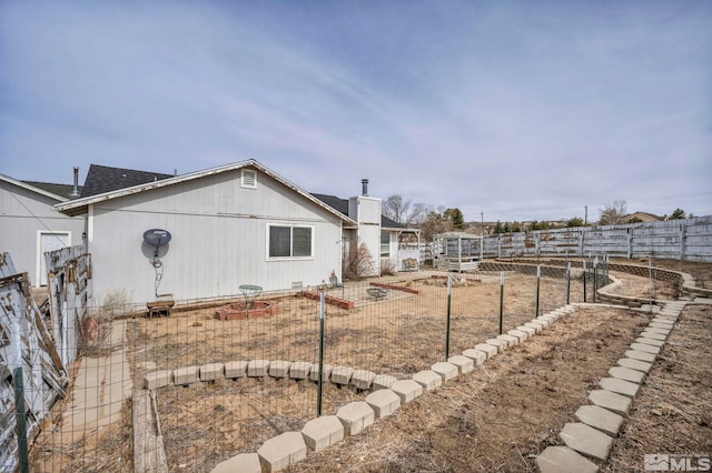 view of yard featuring a vegetable garden and fence