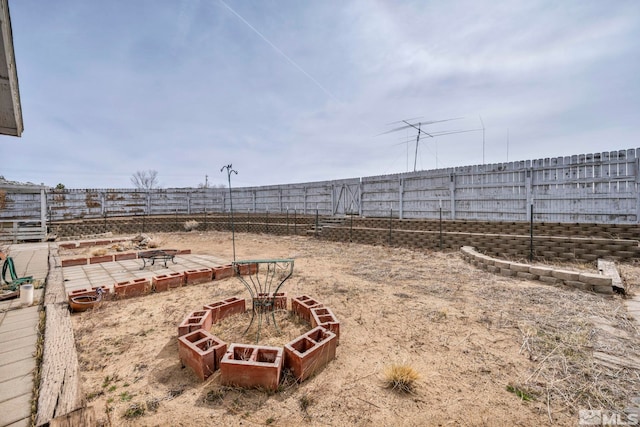 view of yard with a vegetable garden and fence