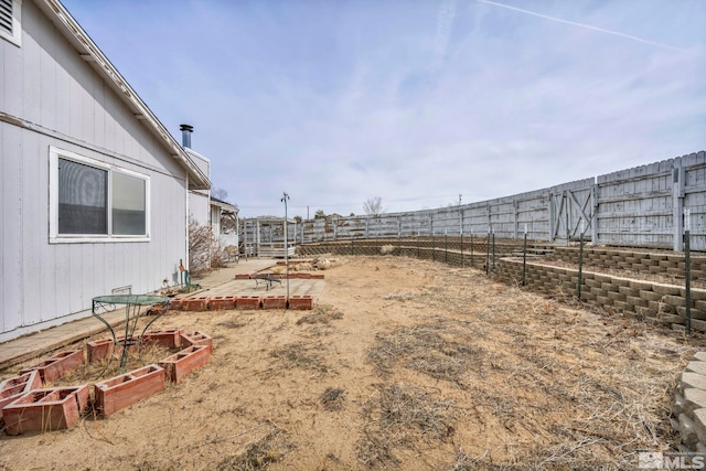 view of yard with a garden, a patio area, and fence