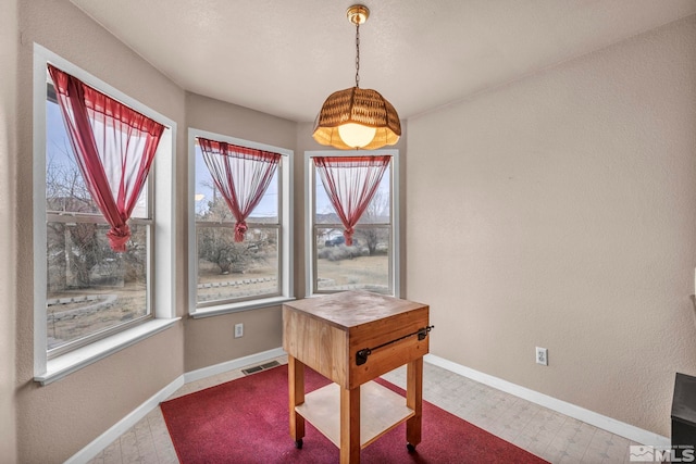 dining room featuring tile patterned floors, visible vents, and baseboards