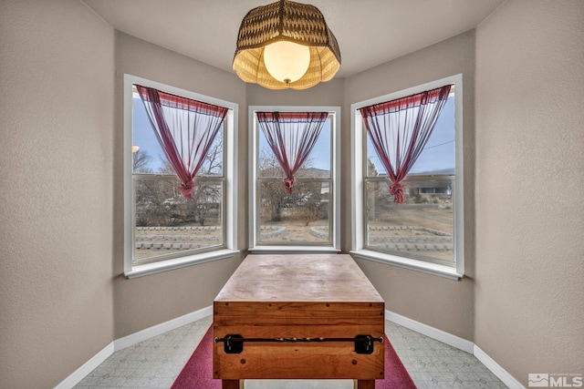 dining room featuring tile patterned floors and baseboards