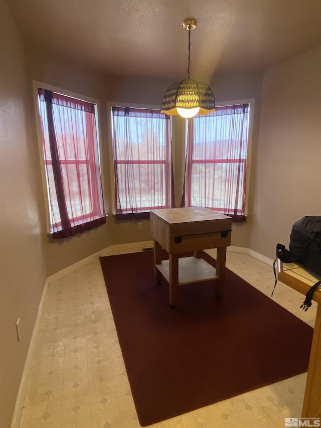 game room featuring tile patterned floors, baseboards, and a healthy amount of sunlight