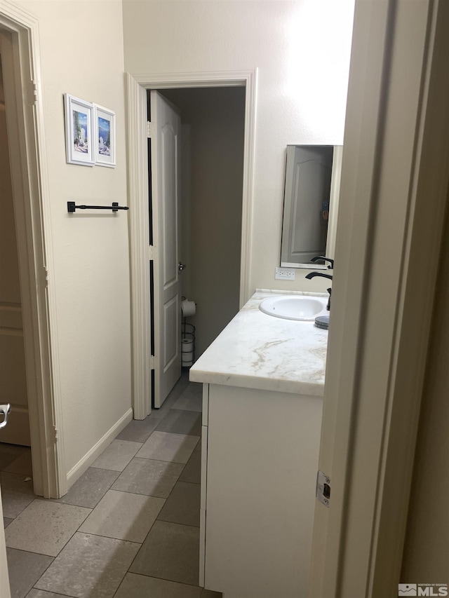 bathroom with vanity and baseboards