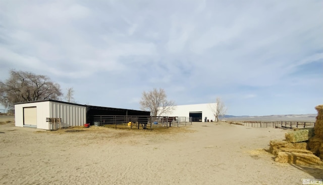 view of stable with a rural view