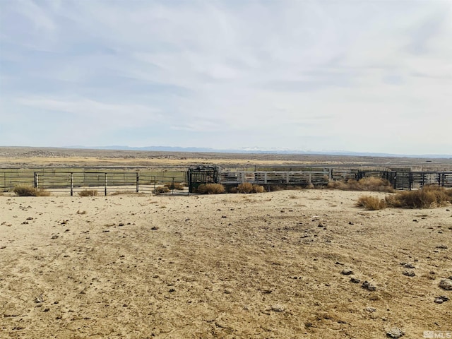 view of yard featuring a rural view and fence