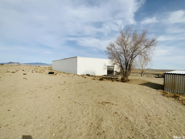 view of yard with an outbuilding and fence