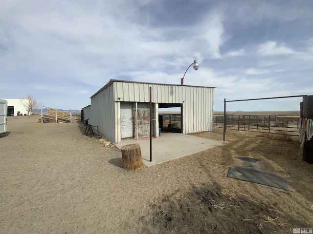 view of pole building with fence