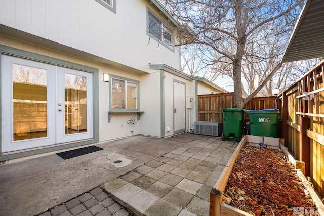 view of patio with french doors and fence