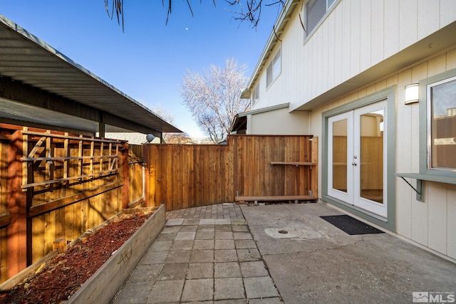 view of patio with french doors and a fenced backyard